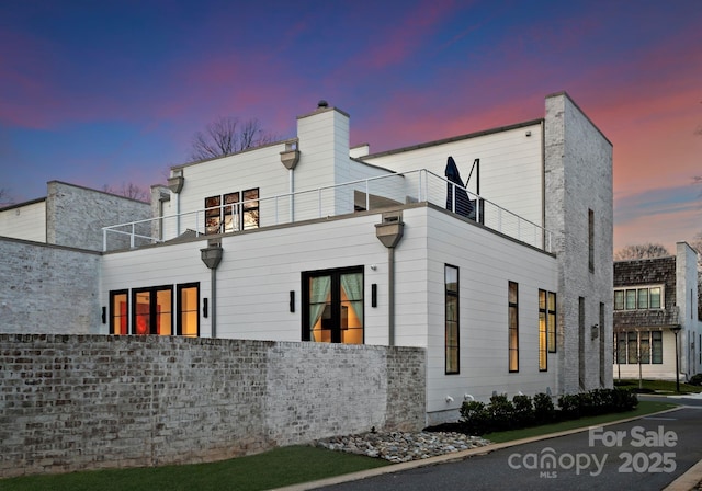 back of property with a balcony