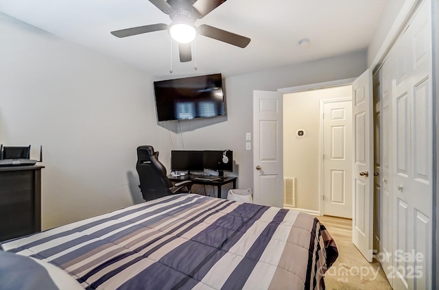 bedroom with light wood-type flooring, visible vents, and a ceiling fan