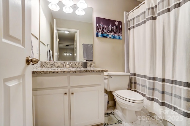 full bathroom featuring tile patterned flooring, a shower with shower curtain, toilet, and vanity