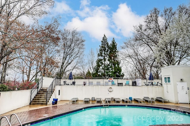 view of swimming pool with a fenced in pool, stairway, a patio area, and fence