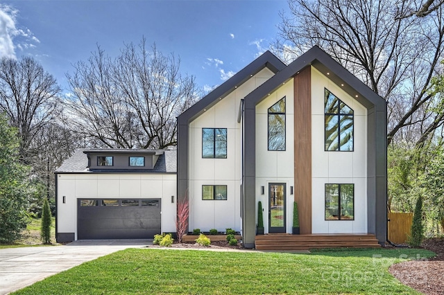 contemporary house featuring driveway, stucco siding, and a front yard