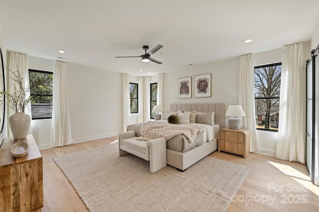 bedroom featuring recessed lighting, multiple windows, and light wood finished floors