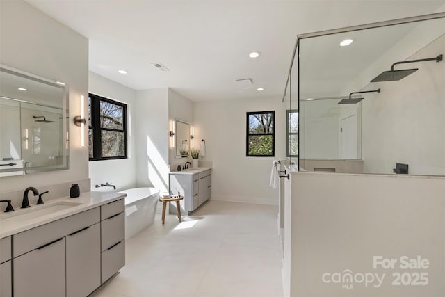 full bath with a healthy amount of sunlight, visible vents, a sink, and a shower with shower door