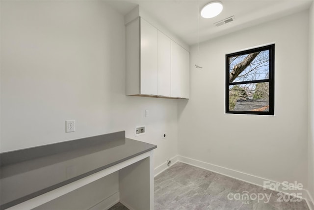 laundry area featuring cabinet space, baseboards, visible vents, hookup for a washing machine, and hookup for an electric dryer