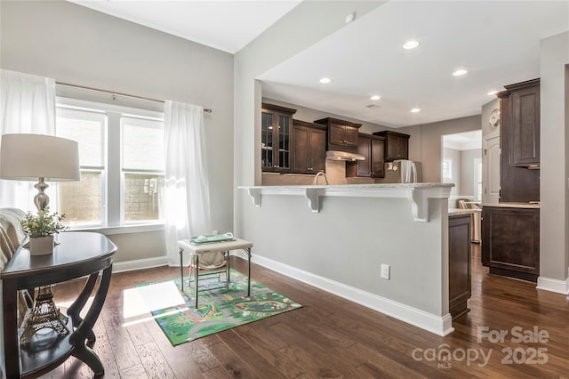 2934 Hiddenbrook Way, Fort Mill, SC 29707 - kitchen with dark brown cabinetry, a healthy amount of sunlight, a breakfast bar area, and freestanding refrigerator