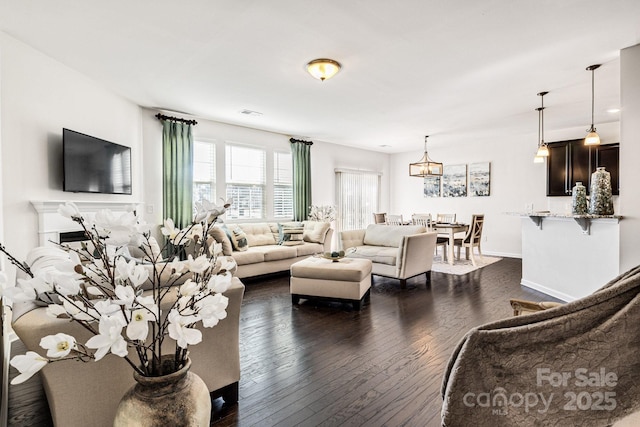 living room with a fireplace, dark wood finished floors, visible vents, and baseboards