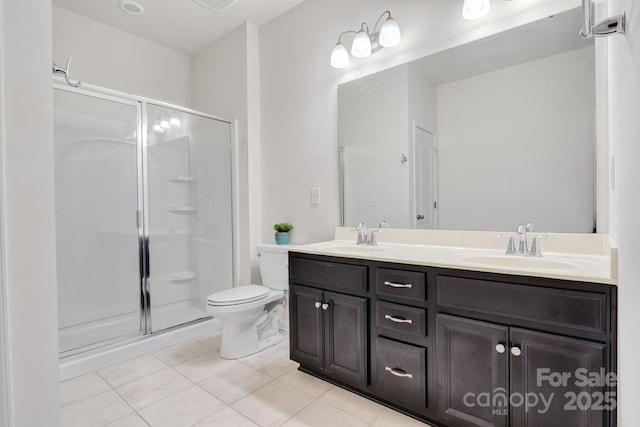 bathroom with double vanity, a stall shower, a sink, and tile patterned floors