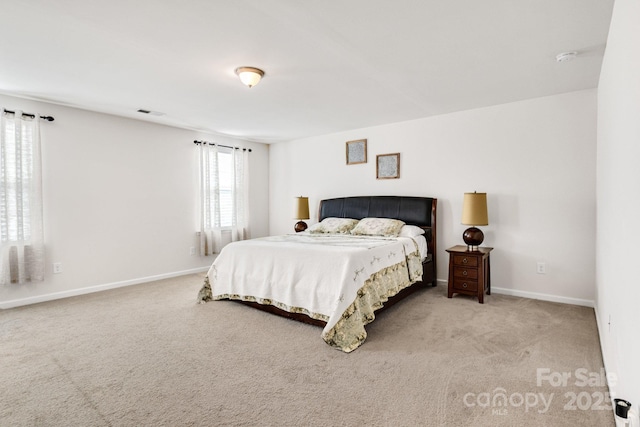 carpeted bedroom with baseboards