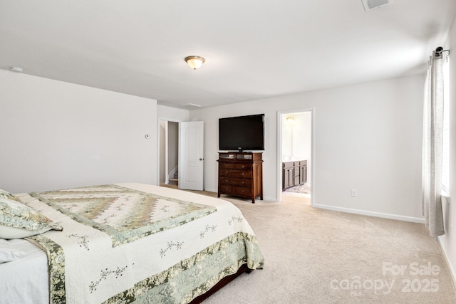 bedroom with light colored carpet, connected bathroom, and baseboards