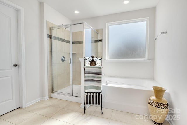 bathroom with tile patterned flooring, a shower stall, a bath, and recessed lighting