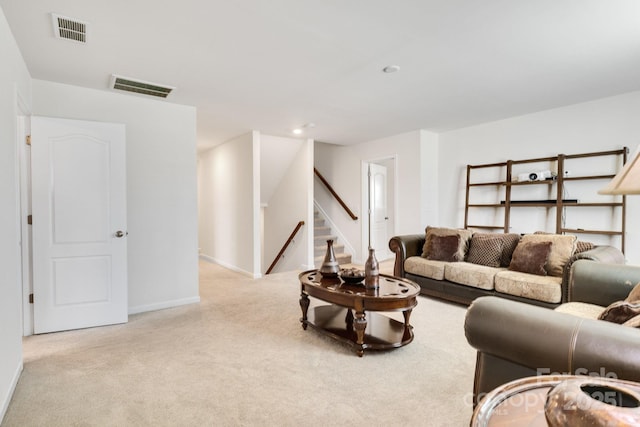 living room featuring carpet floors, stairway, visible vents, and baseboards