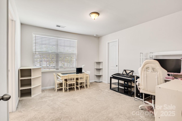 carpeted office featuring visible vents and baseboards