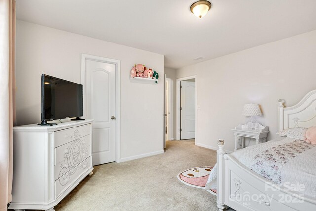 bedroom with light carpet, visible vents, and baseboards