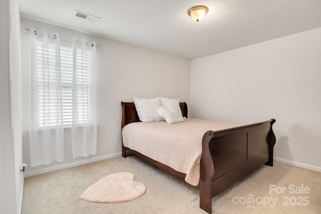 bedroom featuring carpet flooring, visible vents, and baseboards