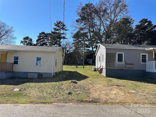 view of property exterior featuring crawl space and a lawn