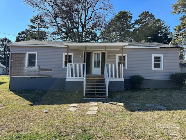 view of front facade with a porch, a front yard, and crawl space