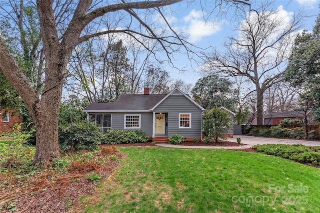 ranch-style home featuring crawl space, a chimney, and a front yard