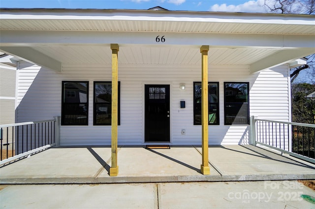 view of exterior entry featuring a porch