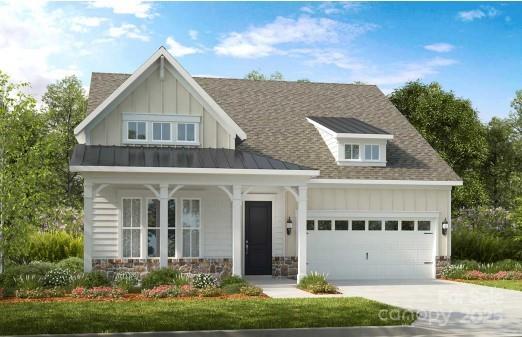 view of front of house with covered porch, an attached garage, board and batten siding, stone siding, and driveway