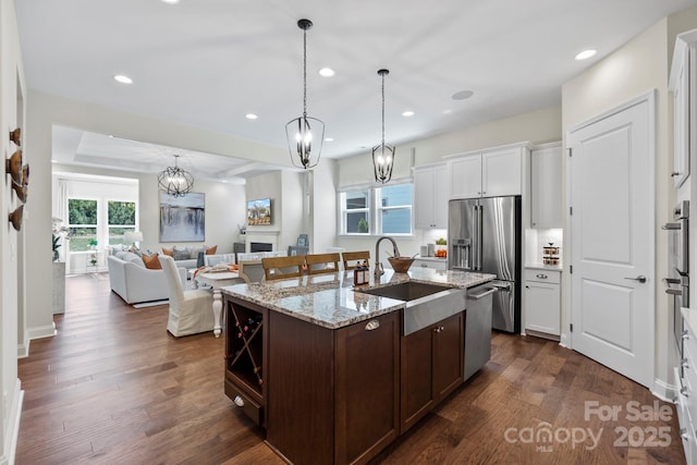 305 Basil Dr, Indian Trail, NC 28079 - kitchen with appliances with stainless steel finishes, a chandelier, open floor plan, dark wood-type flooring, and recessed lighting