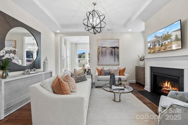 305 Basil Dr, Indian Trail, NC 28079 - living room with a chandelier, wood finished floors, a fireplace with flush hearth, a tray ceiling, and recessed lighting