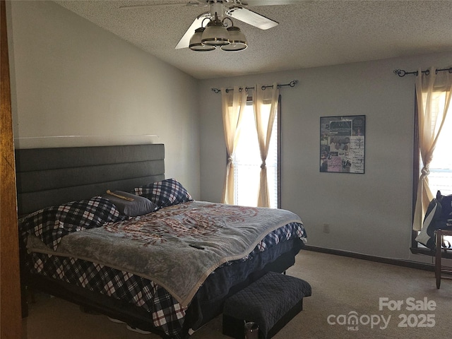 2630 Sloan Dr, Charlotte, NC 28208 - carpeted bedroom with a textured ceiling, baseboards, and ceiling fan