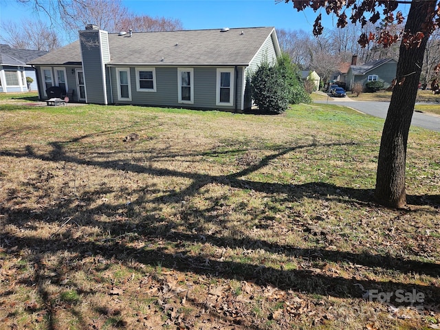 2630 Sloan Dr, Charlotte, NC 28208 - rear view of property featuring a chimney and a lawn