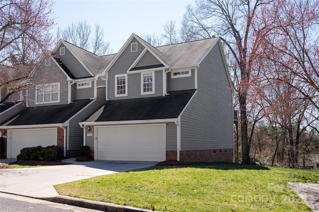 view of front of house with a front lawn, driveway, and an attached garage