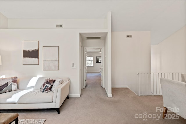 living room featuring light colored carpet and visible vents