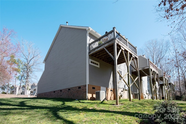 rear view of house featuring crawl space, central AC, a lawn, and a wooden deck