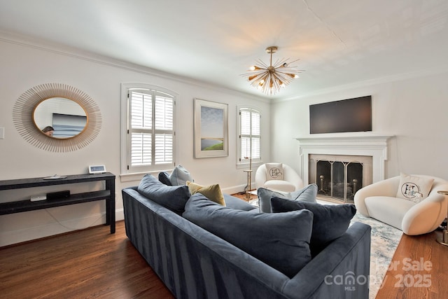 living area with ornamental molding, dark wood-style flooring, and a fireplace