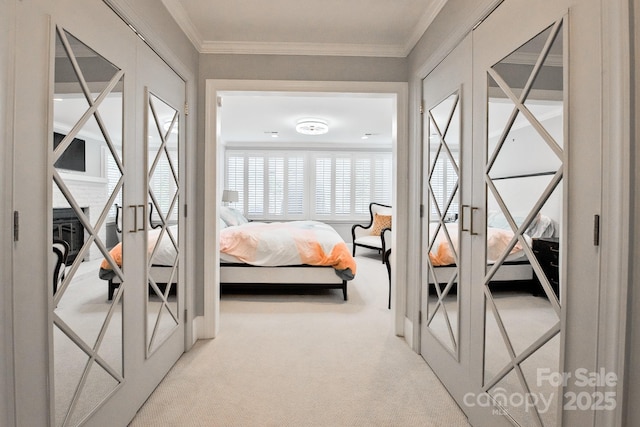 carpeted bedroom featuring ornamental molding and french doors