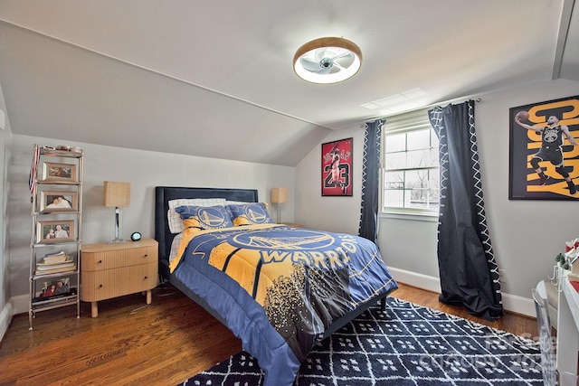 bedroom with lofted ceiling, baseboards, and wood finished floors