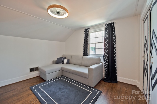 living room with lofted ceiling, visible vents, dark wood finished floors, and baseboards