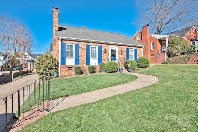 view of front of home with brick siding, crawl space, a chimney, and a front lawn