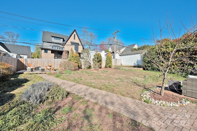 view of yard with fence and a patio