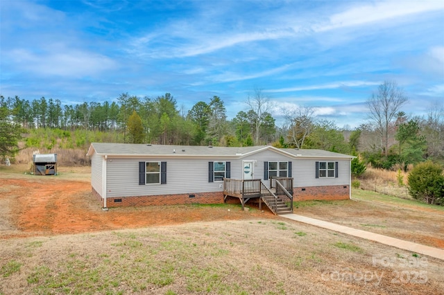 manufactured / mobile home featuring crawl space, a front lawn, and a wooden deck