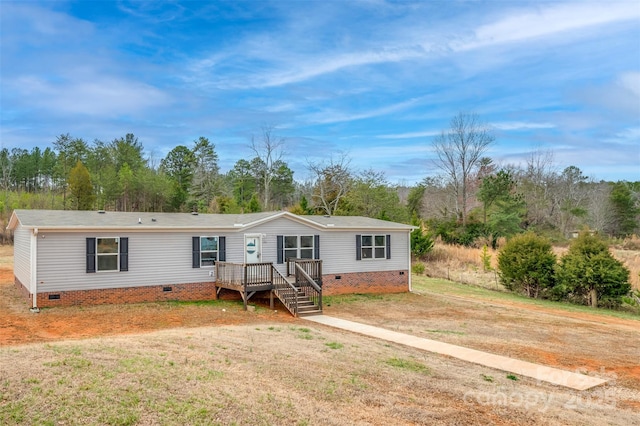 manufactured / mobile home with crawl space, a front yard, and a wooden deck