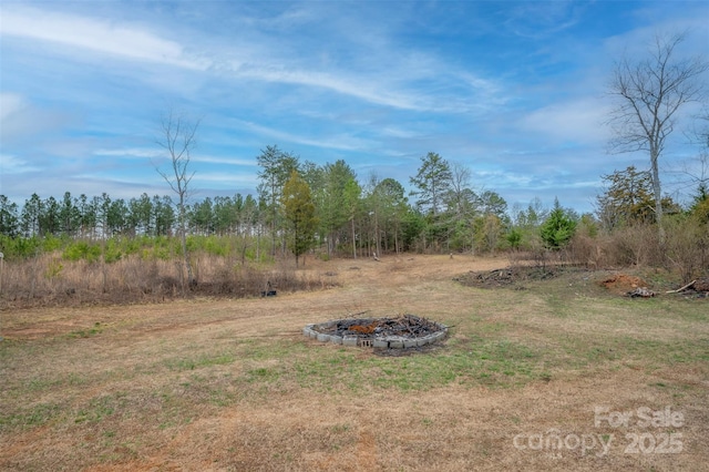 view of yard with a fire pit