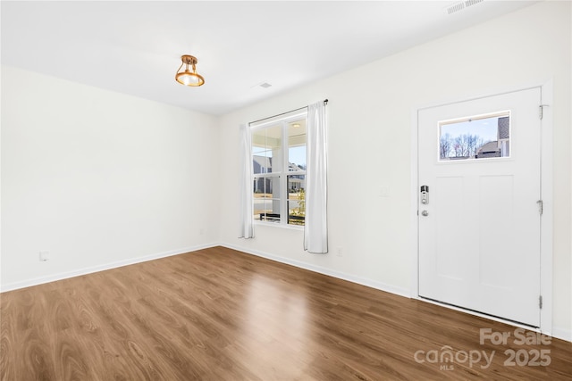 entrance foyer with baseboards and wood finished floors