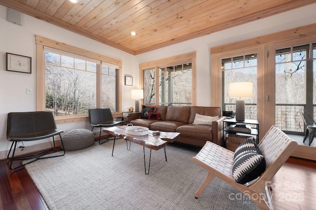 living room featuring a healthy amount of sunlight, wooden ceiling, ornamental molding, and hardwood / wood-style floors