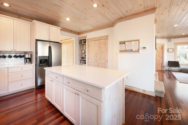 kitchen featuring wooden ceiling, light countertops, stainless steel refrigerator with ice dispenser, dark wood finished floors, and crown molding