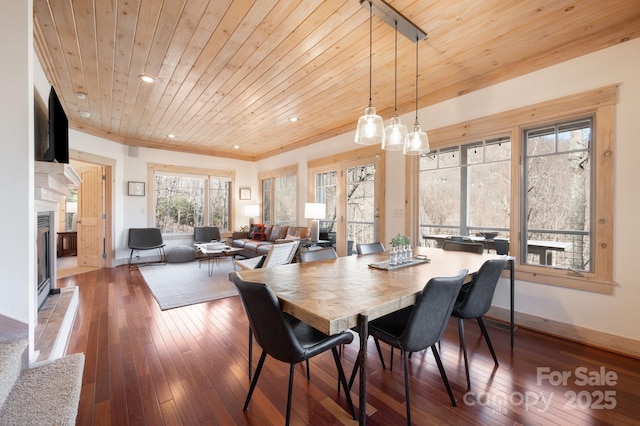 dining space with recessed lighting, a fireplace with flush hearth, wood ceiling, baseboards, and wood-type flooring