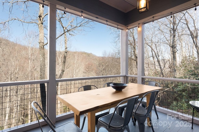 balcony with a sunroom and a forest view