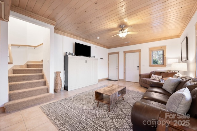 living room featuring light tile patterned floors, wood ceiling, stairs, and crown molding