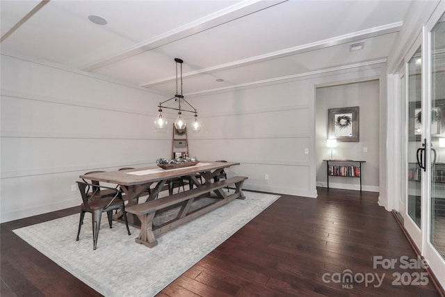 dining room featuring dark wood finished floors, beamed ceiling, and baseboards