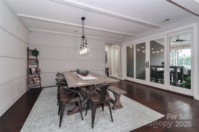 dining space with beam ceiling, dark wood-style floors, visible vents, and baseboards