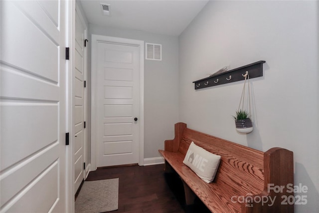 mudroom with dark wood-style floors, visible vents, and baseboards