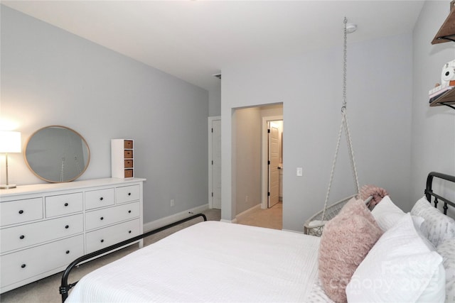 bedroom with light colored carpet and baseboards