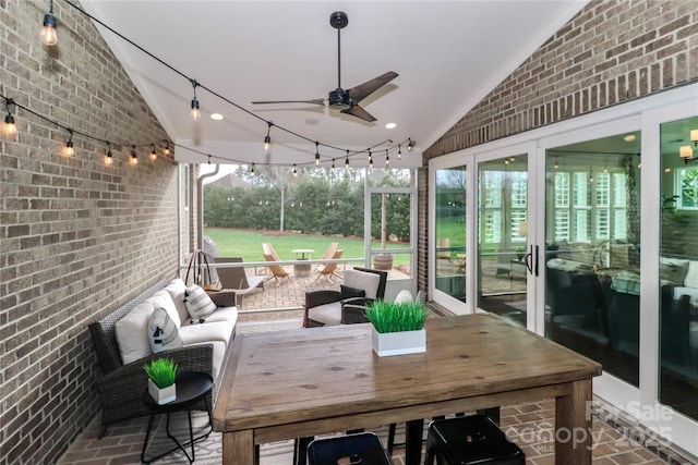 sunroom / solarium with ceiling fan and lofted ceiling